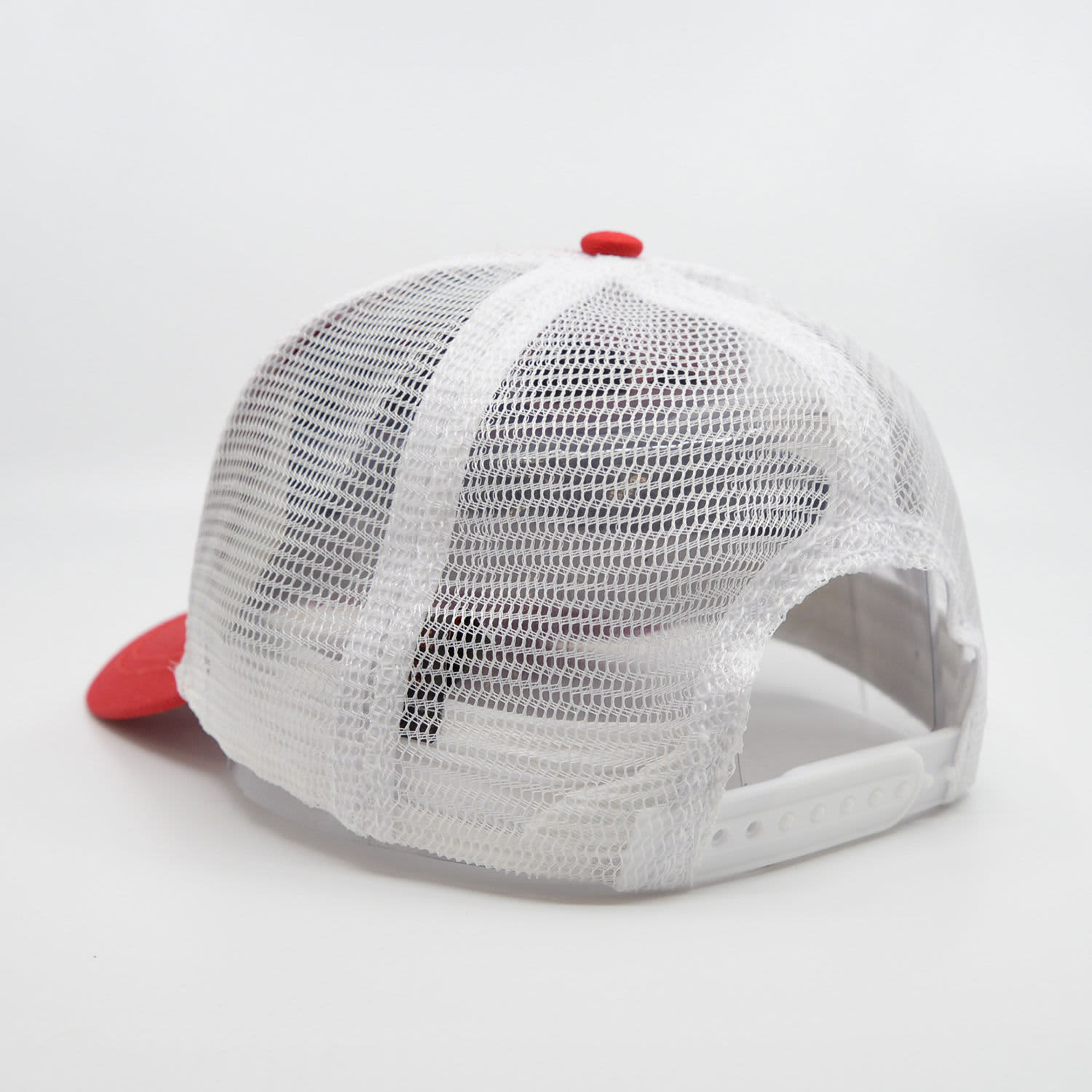 A red and white trucker cap featuring a mesh back and an adjustable strap. It includes a logo.