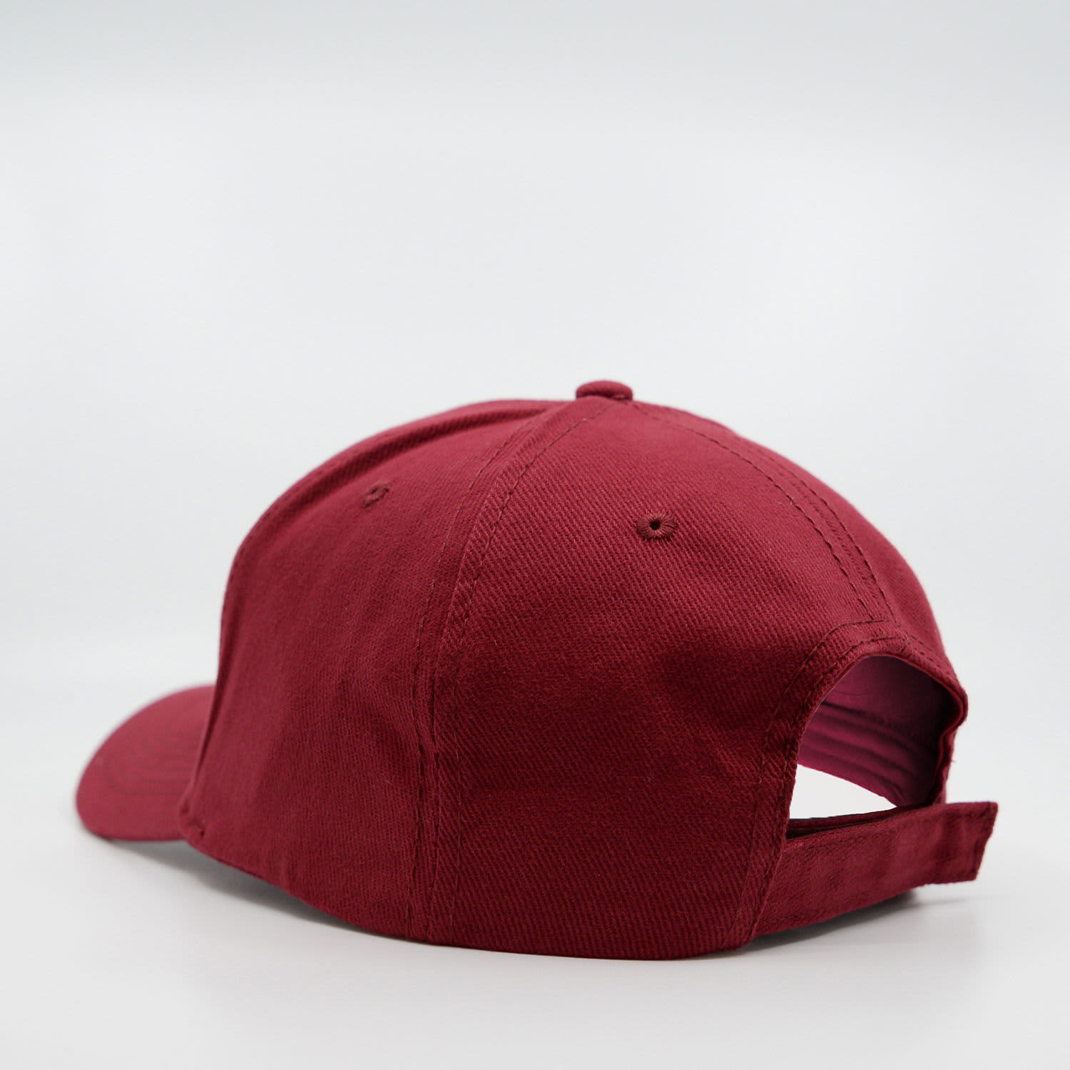 A maroon six-panel brushed cotton cap featuring a rear adjustable strap and a logo.