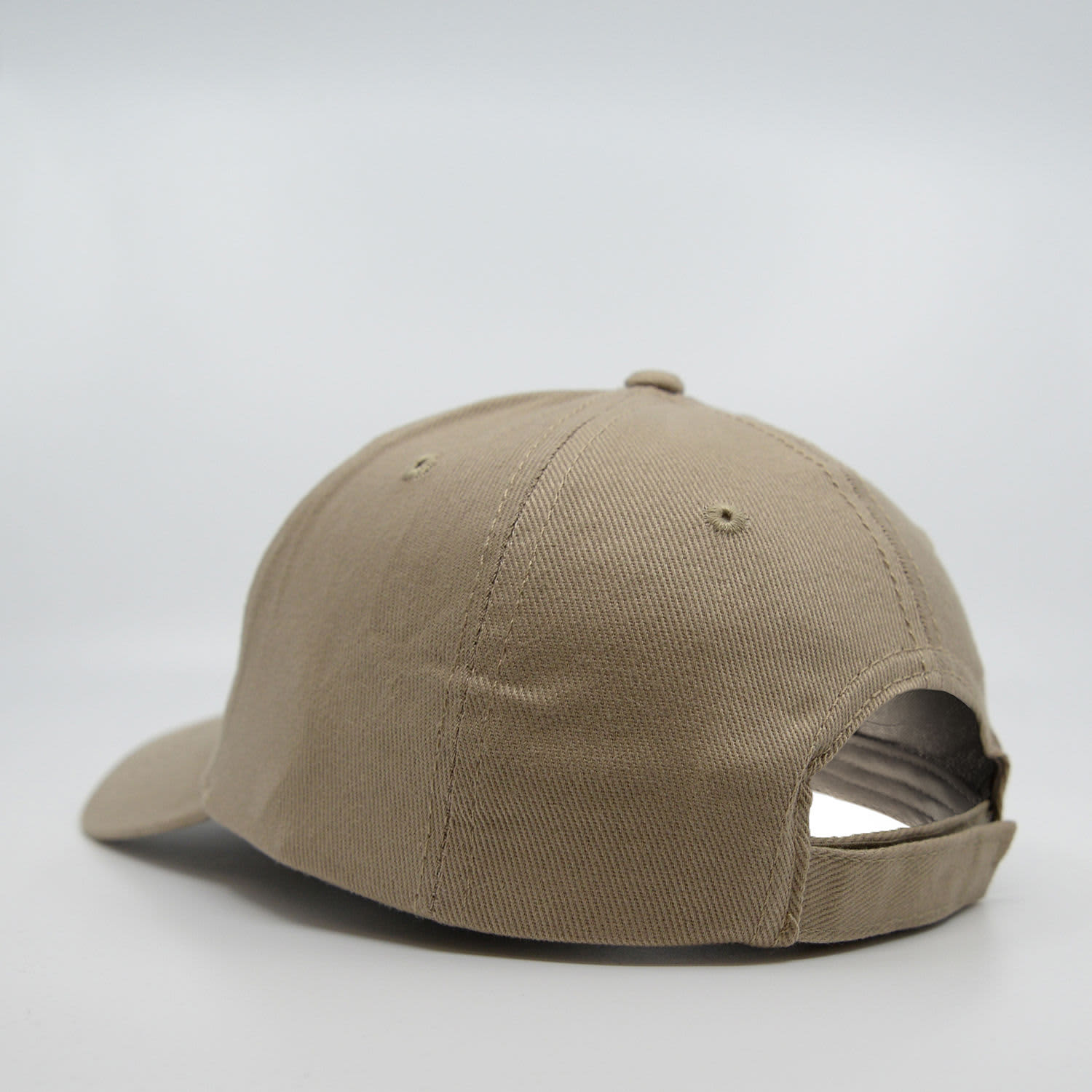 A khaki six-panel brushed cotton cap with a curved brim and adjustable strap at the back.