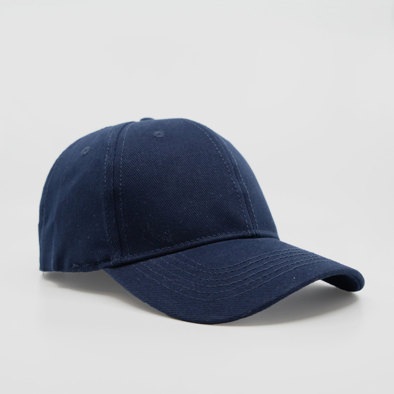 A navy blue six-panel brushed cotton cap with a curved peak and a logo on the front.