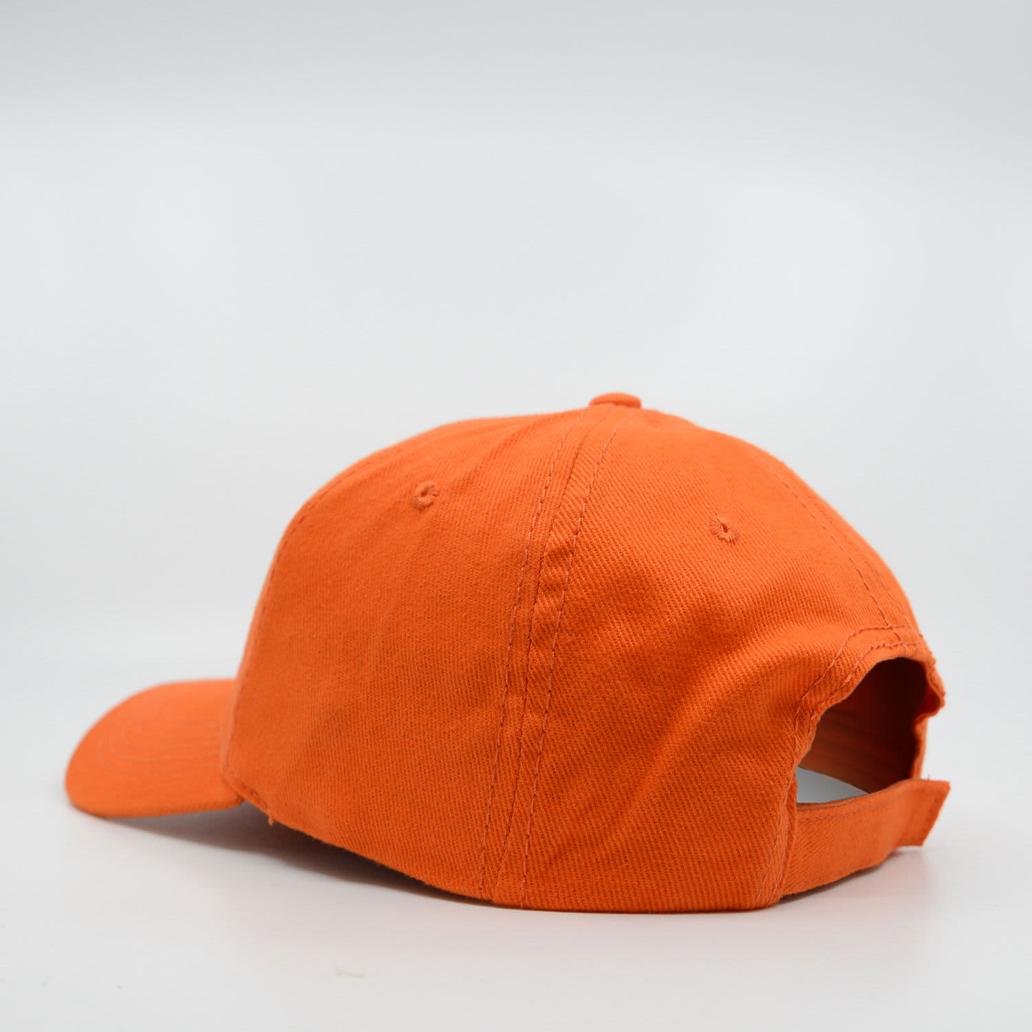 An orange six-panel brushed cotton cap featuring a back opening and adjustable strap.