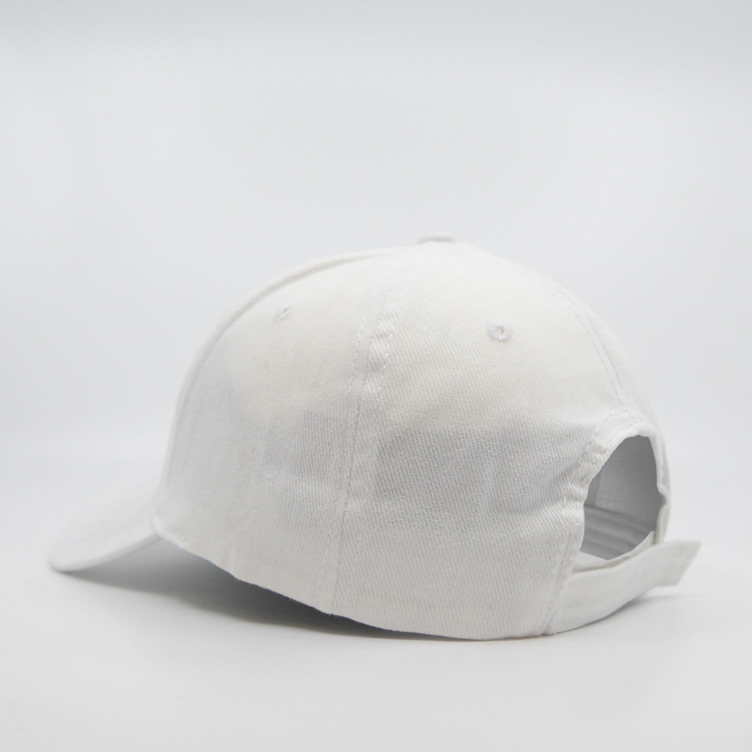 A white six-panel brushed cotton cap with a curved brim and an adjustable strap at the back.