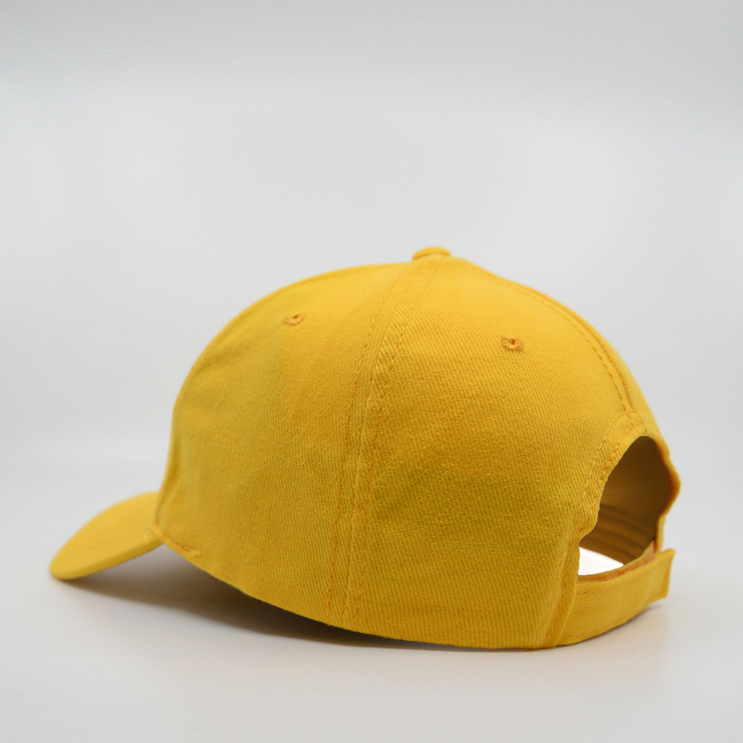 A yellow brushed cotton cap with a six-panel design and an adjustable strap at the back.