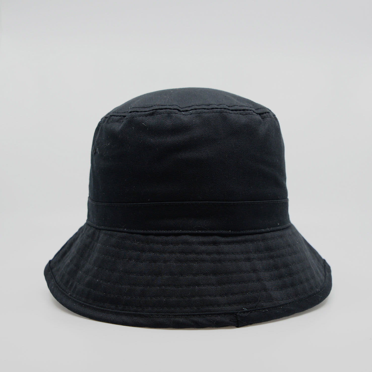 A black bucket hat with a wide brim and a structured design, featuring a logo on the side.