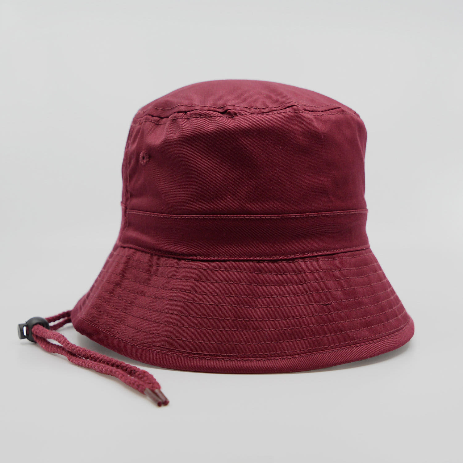 A maroon bucket hat with a chin strap, featuring a seamless brim and structured design.