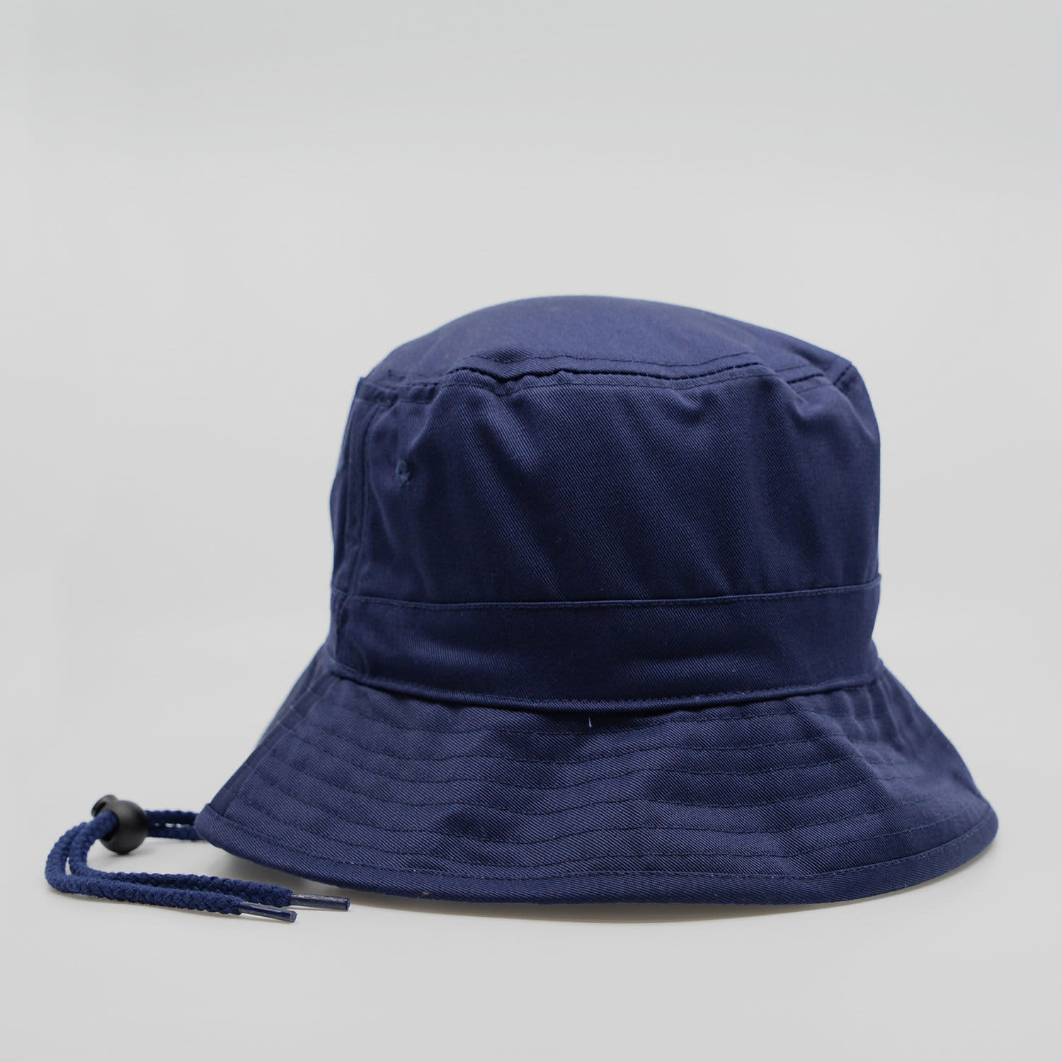 A navy blue bucket hat featuring a logo and a chin strap for secure wear.