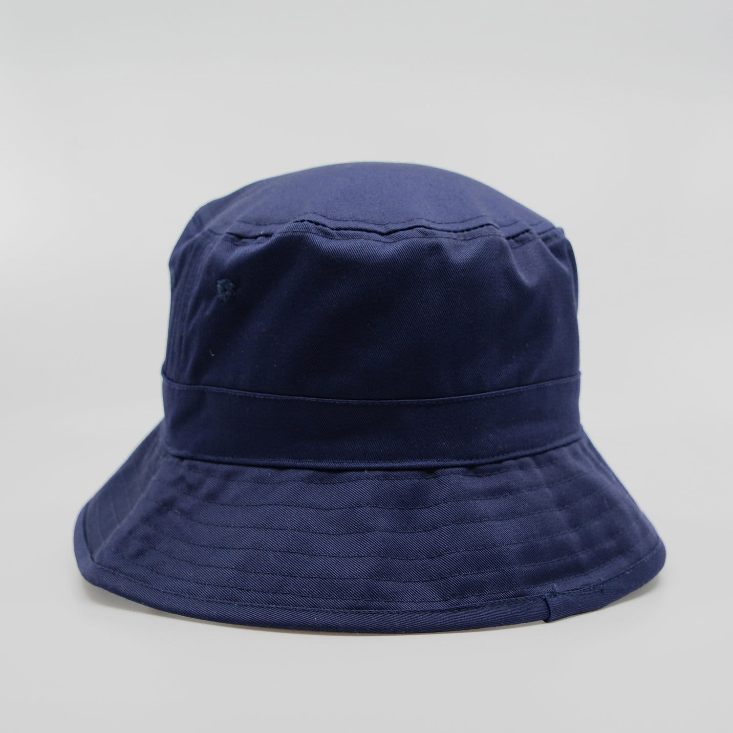 A navy blue bucket hat featuring a wide brim and a logo on the side.