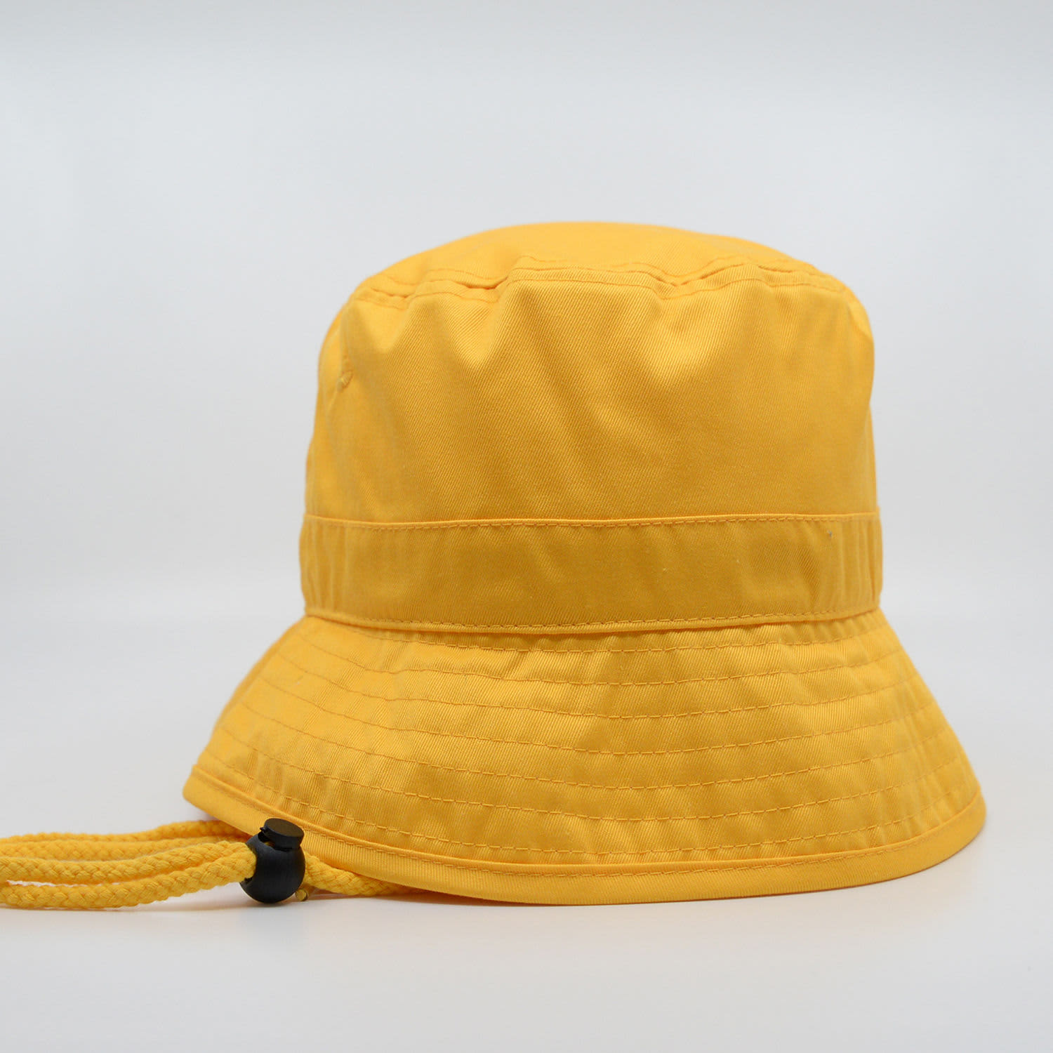A yellow bucket hat with a drawstring, featuring a rounded crown and wide brim.