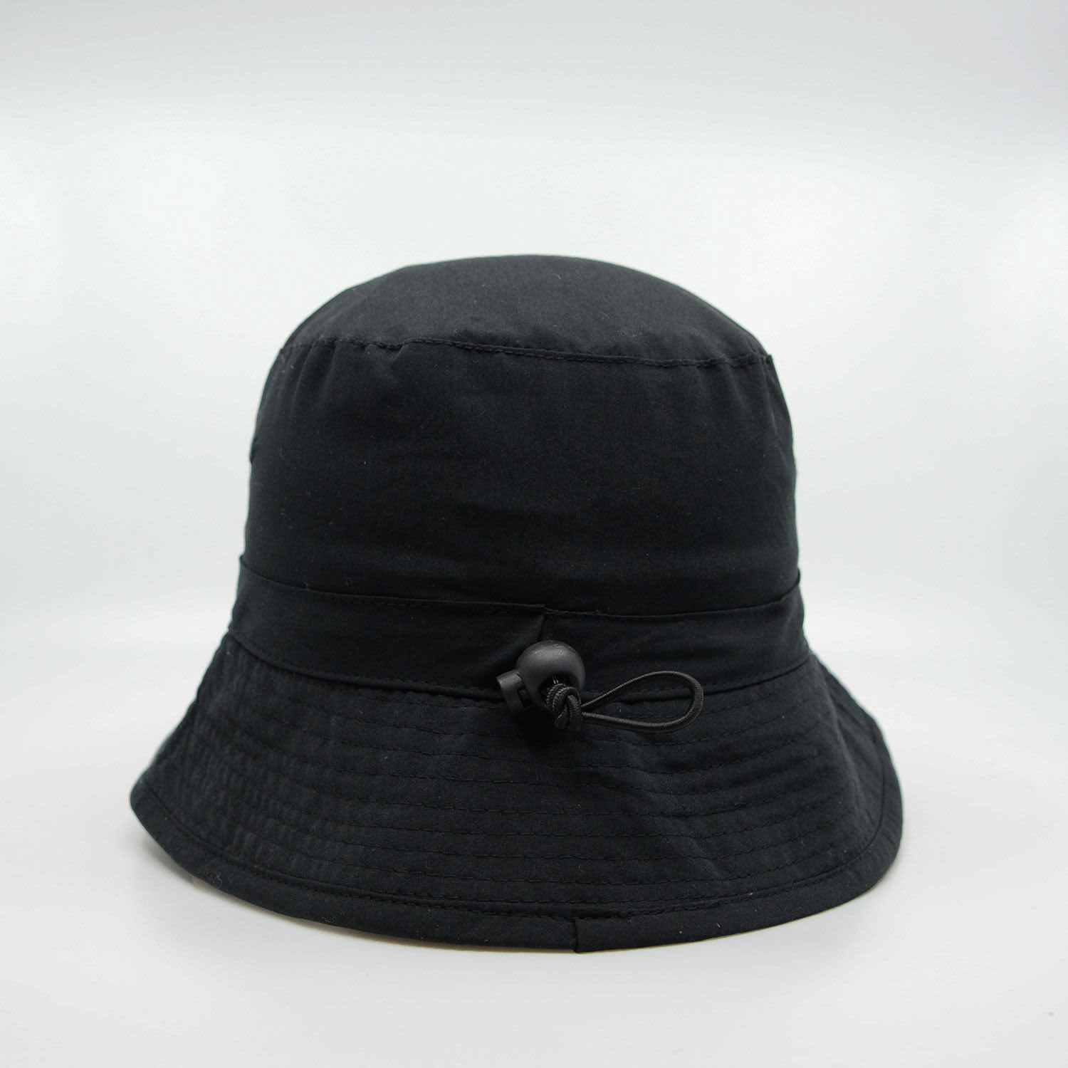 A black microfibre bucket hat featuring an adjustable drawstring and a logo. Suitable for headwear collection.