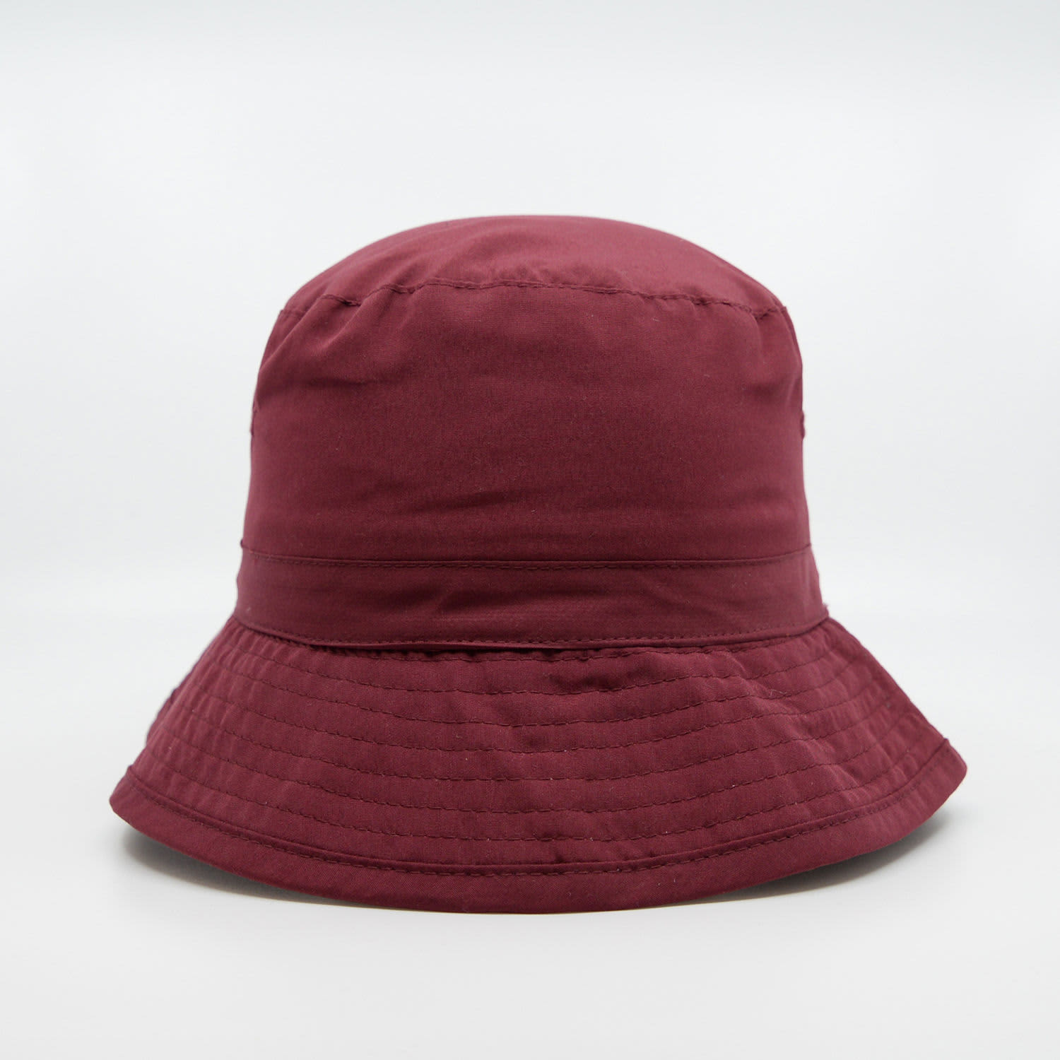 A maroon microfibre bucket hat with a wide brim, featuring a stitched design and a logo.