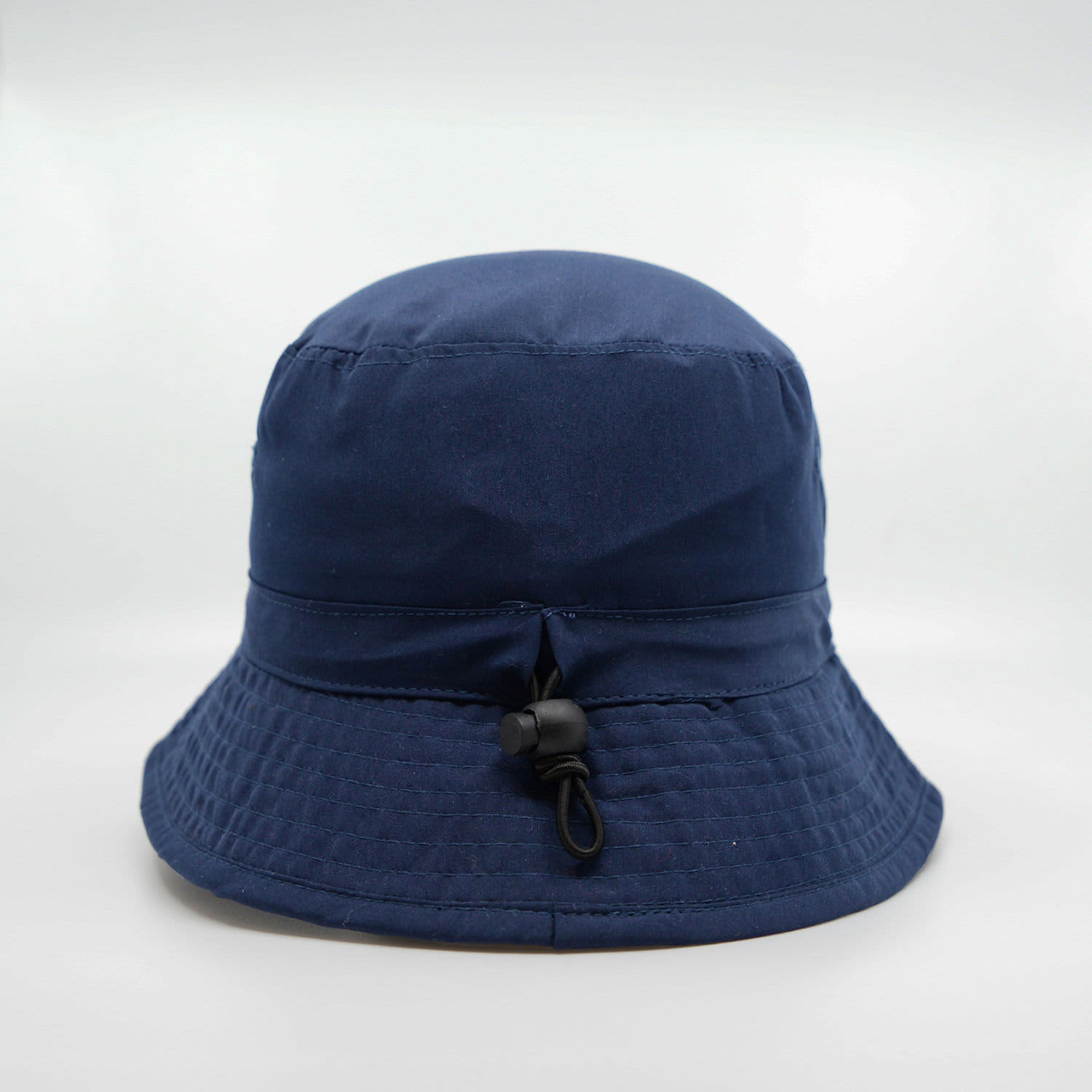 A navy blue microfibre bucket hat with a drawstring and an adjustable toggle at the back.