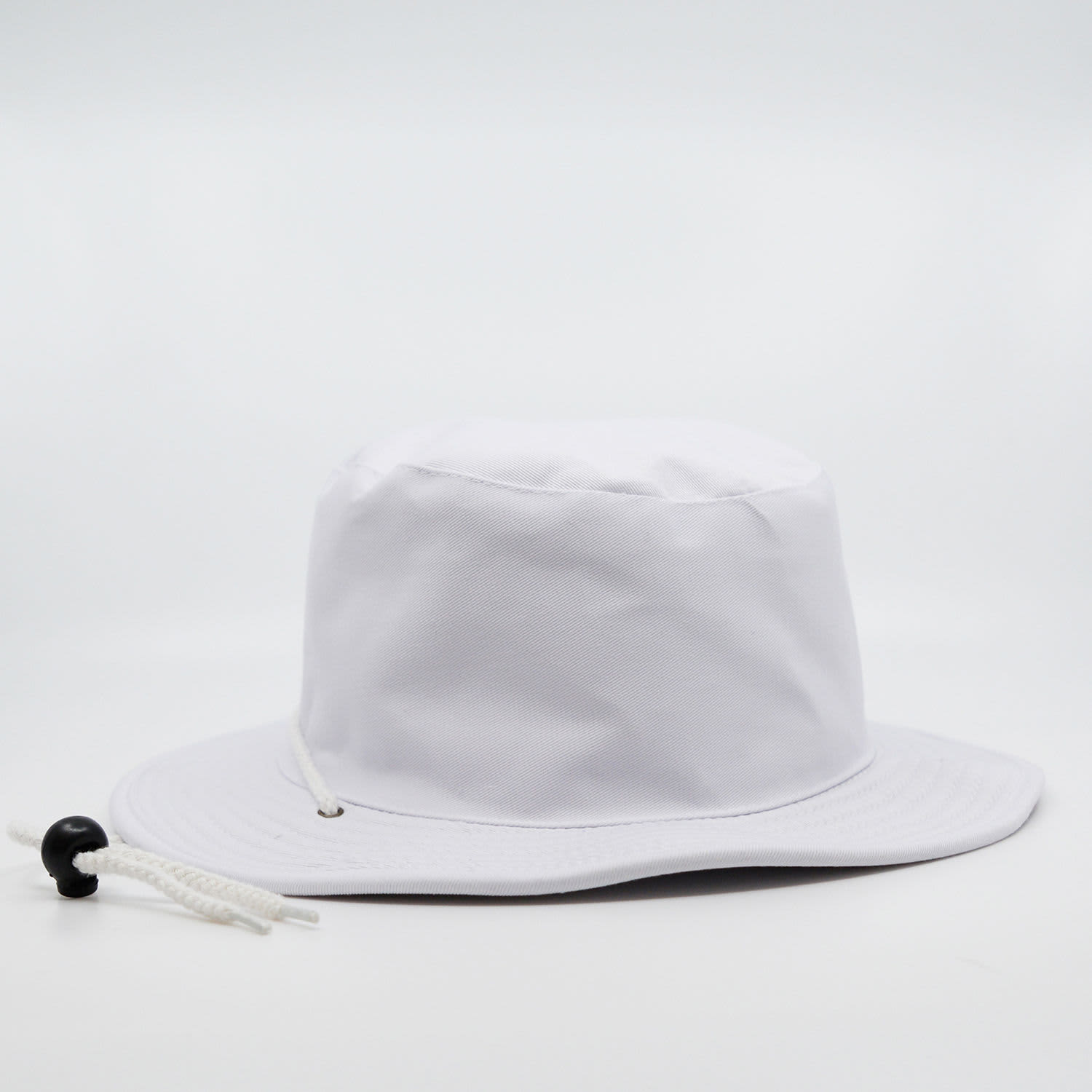 A white wide brim hat with a toggle adjustment. It features a simple design suitable for outdoor wear.