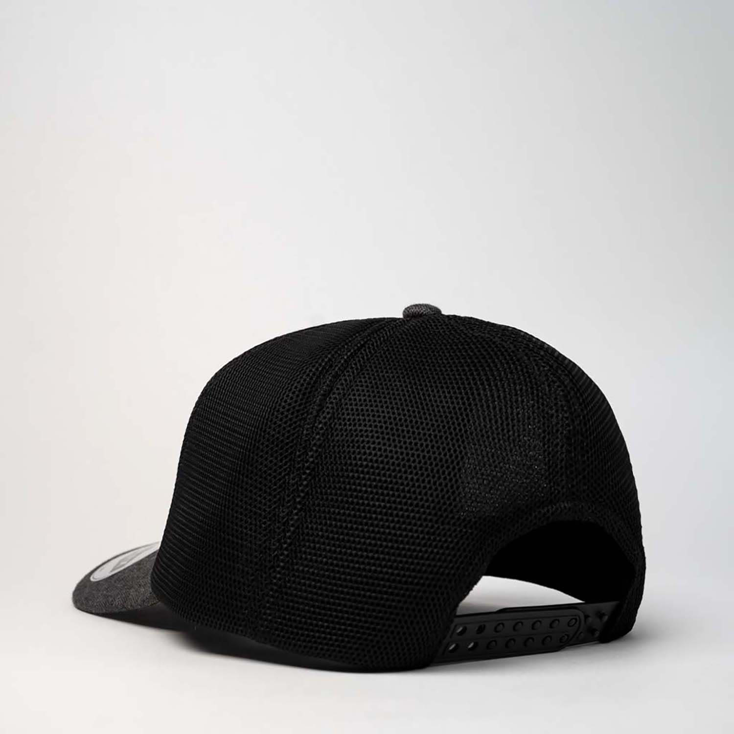 A black trucker cap featuring a mesh back and a curved brim, with an adjustable strap.