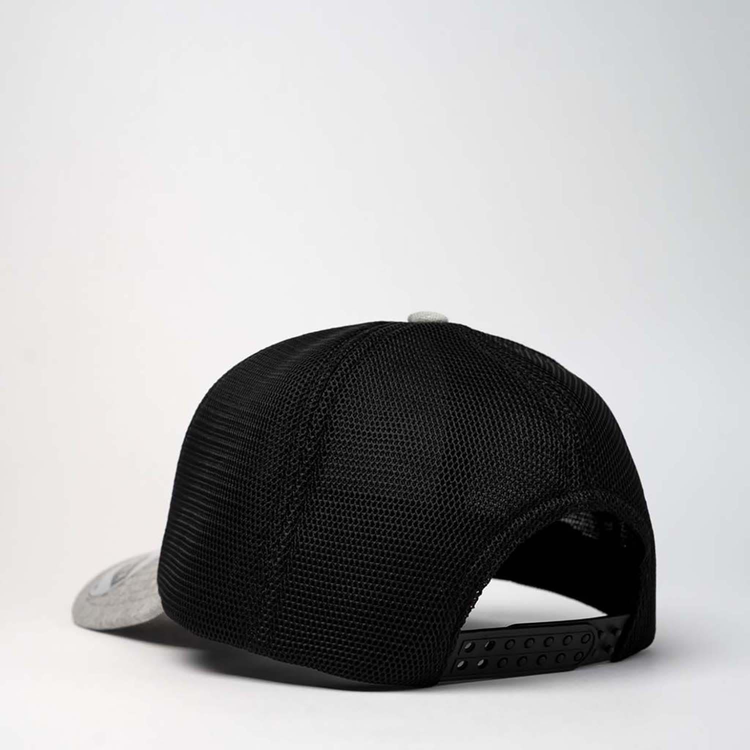 A black and grey adults comfort trucker cap featuring a logo on the front and a mesh back.