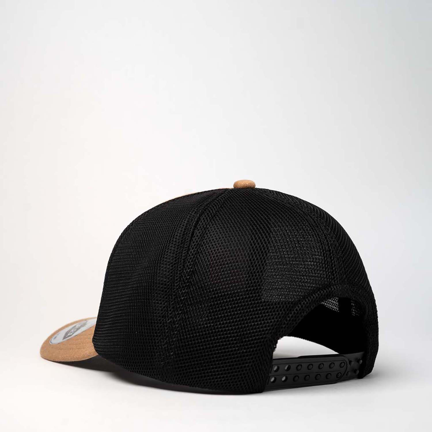 A black trucker cap with a tan front panel and mesh back, featuring an adjustable strap and a logo.