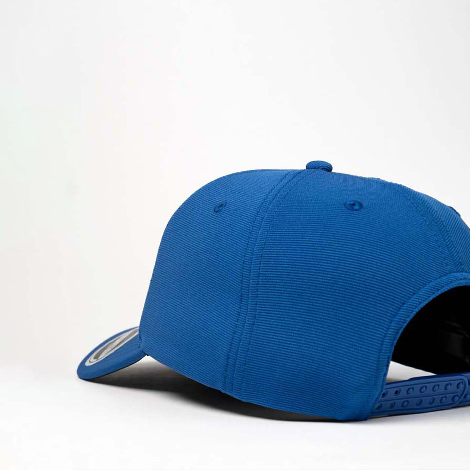 A blue recycled cap with a curved peak and adjustable strap, featuring a logo on the side.