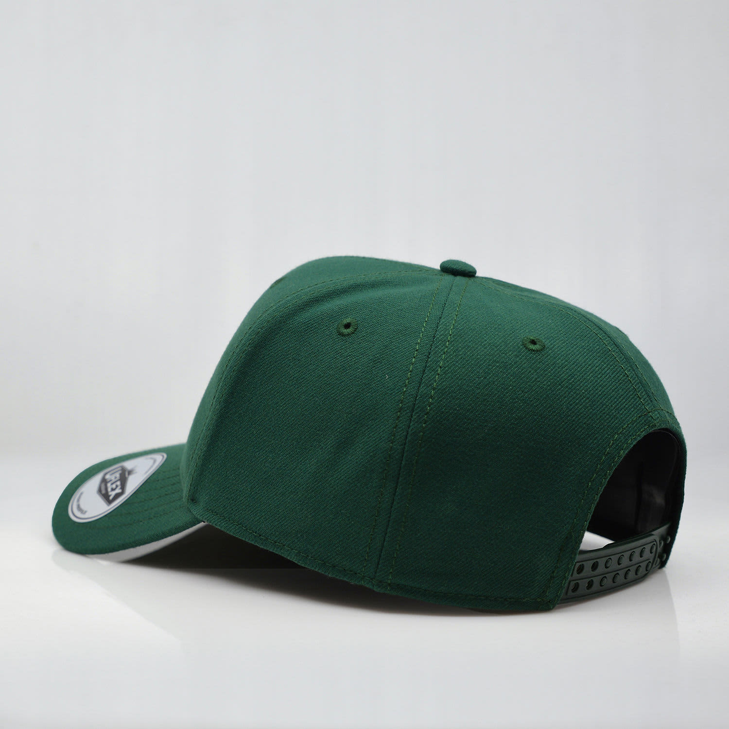A green six-panel snapback cap with a logo on the front and a plastic adjustable strap at the back.