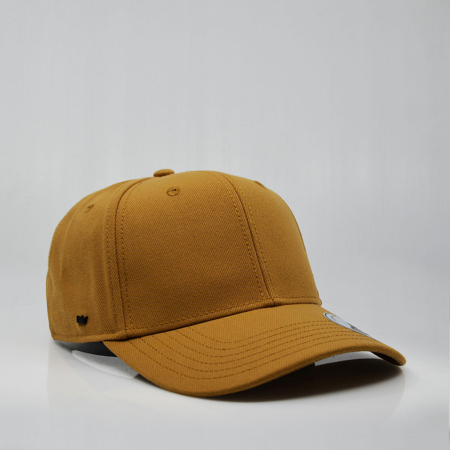 A mustard-coloured snapback cap with a structured six-panel design and a logo.