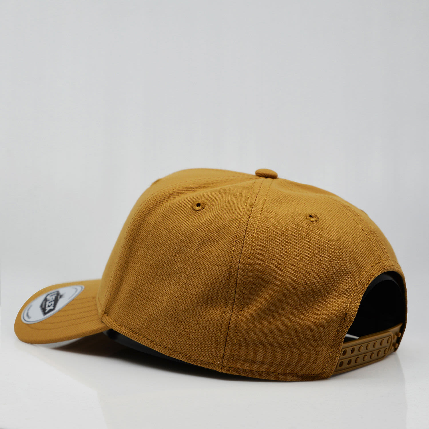 A yellow six-panel snapback cap with a curved brim and a logo on the side.