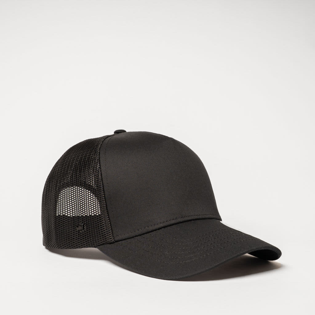 A black five-panel trucker cap featuring a mesh back and a curved peak, with a logo on the side.