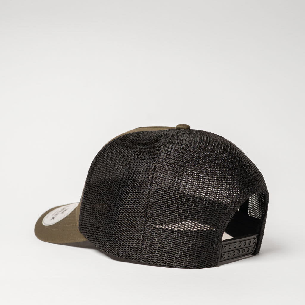 A trucker cap featuring an olive green front and black mesh back, along with an adjustable strap and a logo.