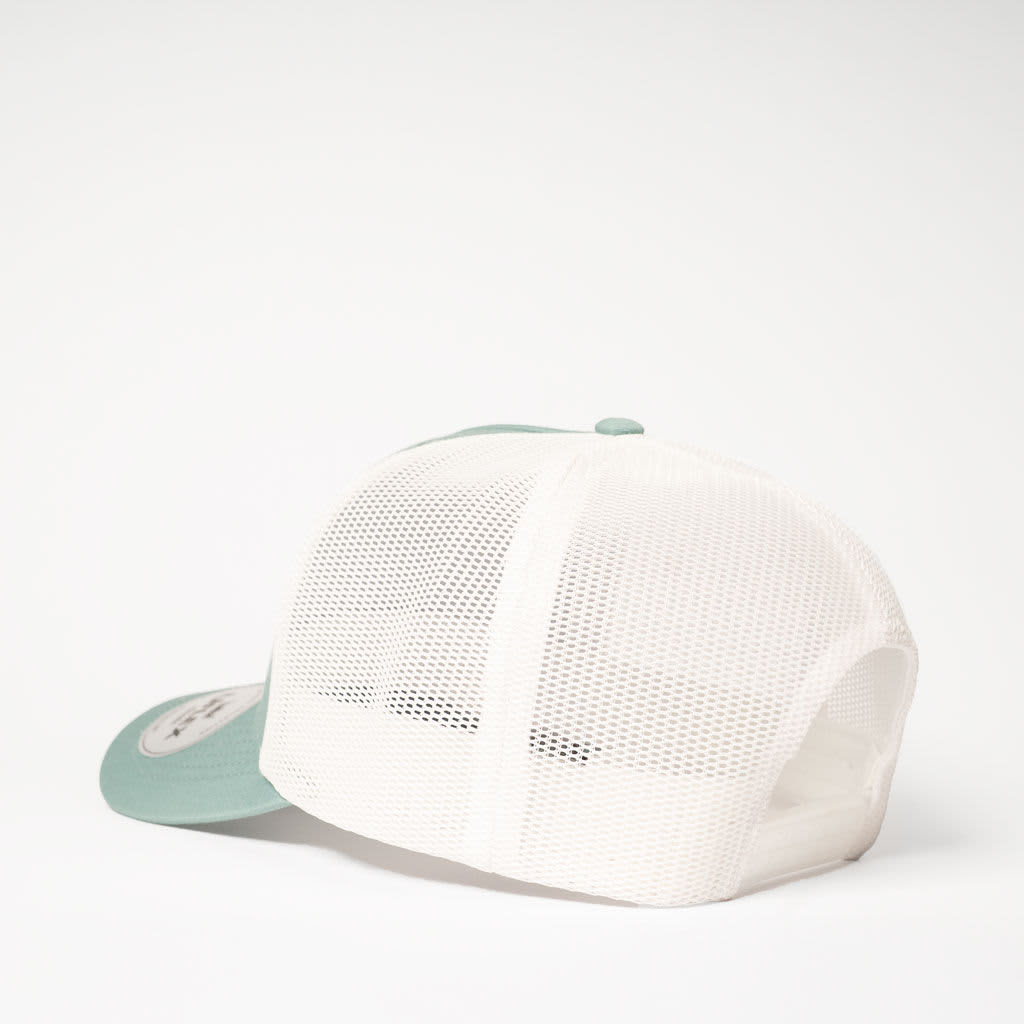 A trucker cap in teal with a white mesh back and an adjustable snap closure. Includes a logo on the front.