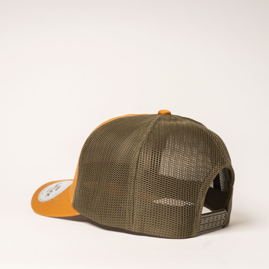 A five-panel trucker cap featuring an olive green mesh back and a mustard yellow front, with a logo on the front.