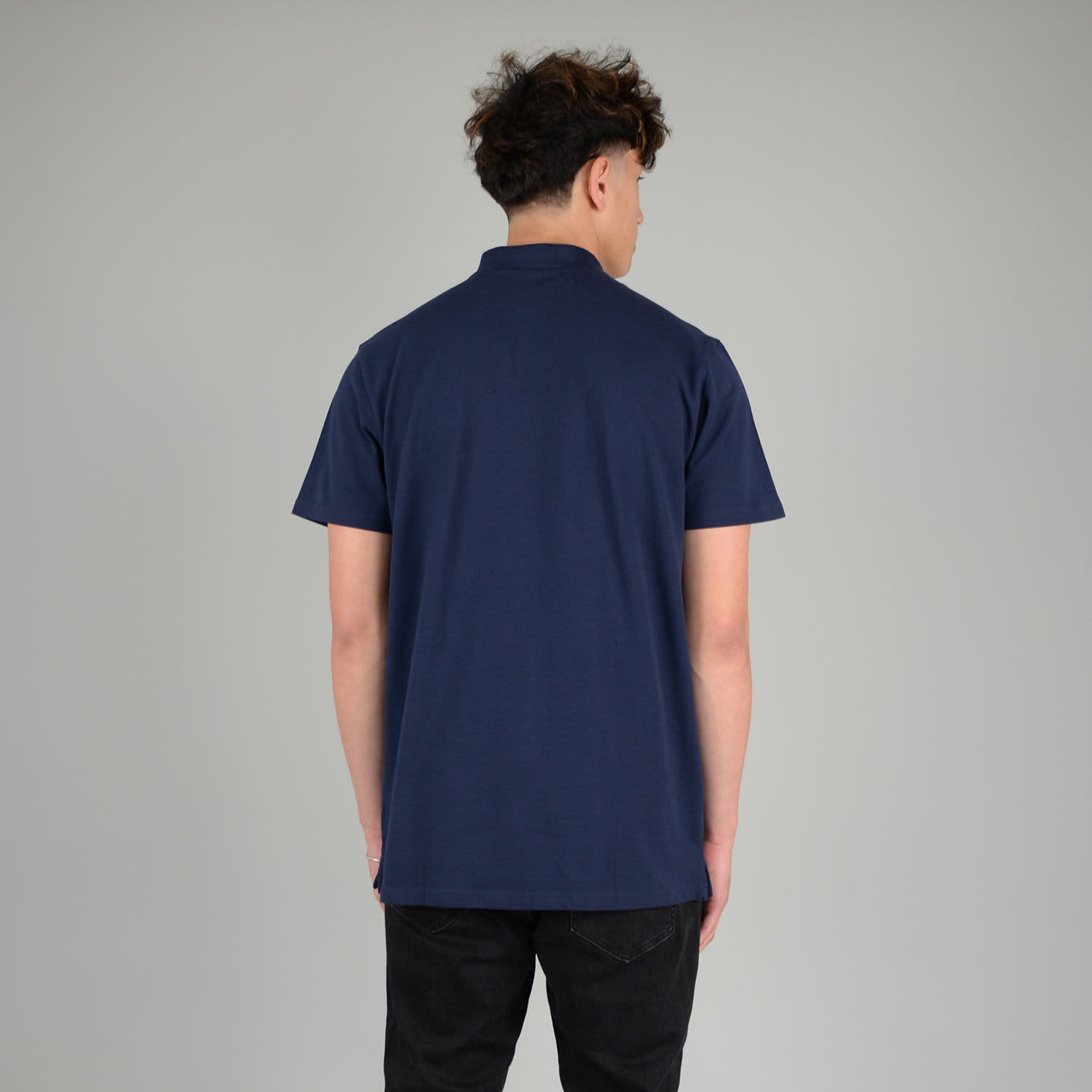 A navy blue adult polo shirt with a collar and short sleeves, featuring a logo on the back.