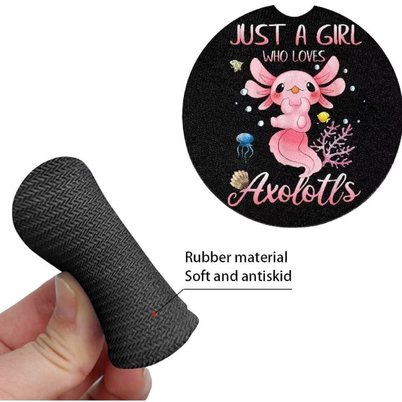 A hand holding a black neoprene car coaster featuring a colourful axolotl design and text.