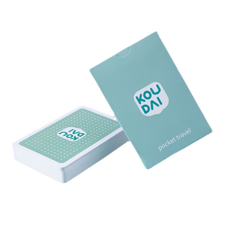 A deck of playing cards in a mint green box with a logo, featuring a dotted design on the card back.