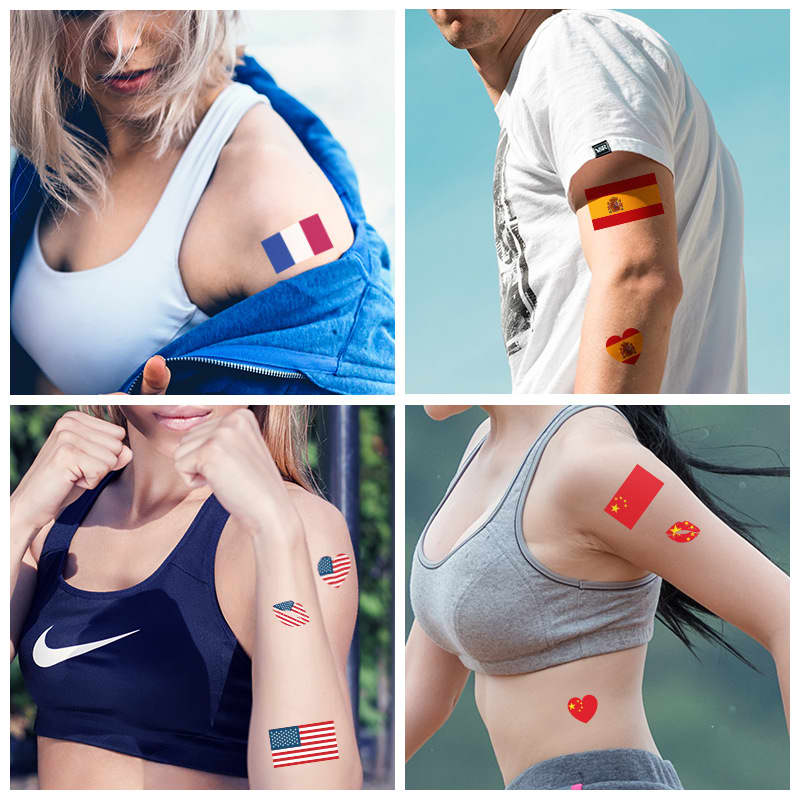 A collection of temporary tattoos displayed on arms, featuring various flags and heart designs in vibrant colours.