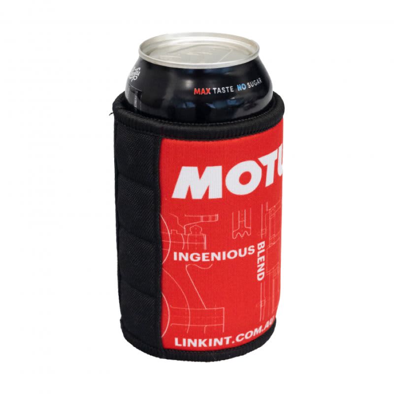 A drink can is in a red and black magnetic stubby holder, featuring a logo and a textured design.