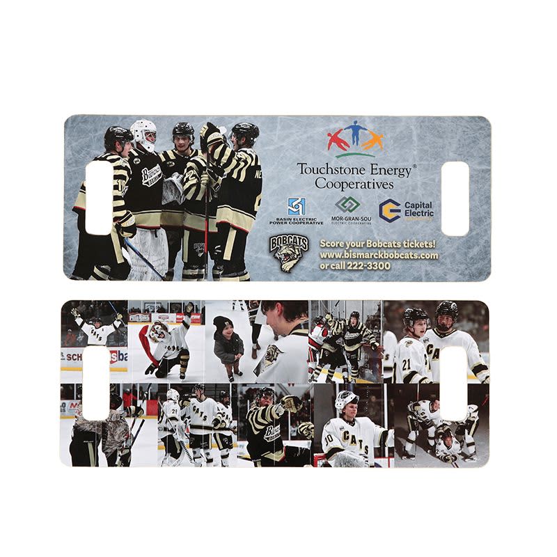 A promotional cardboard clapper featuring images of hockey players in black and gold uniforms, with a logo on the design.