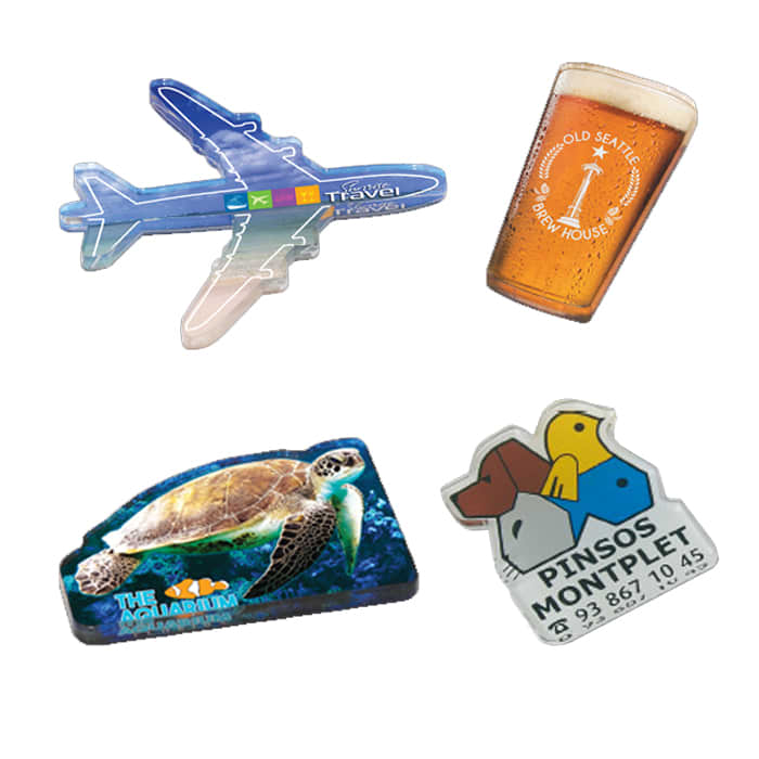Acrylic magnets featuring an aeroplane, a beer glass, a sea turtle, and a colourful logo. Various vibrant colours are present.