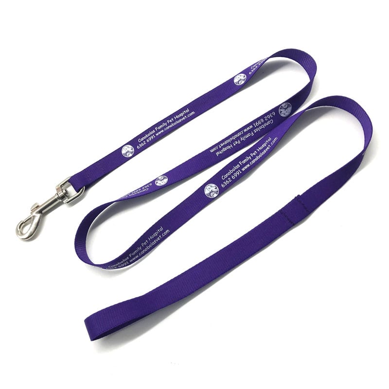 A purple dog leash with a silver clip and a logo, featuring printed text along its length.