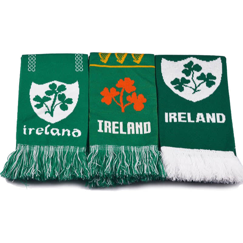 Three green custom knitted scarves featuring various designs, including shamrocks and the word "Ireland."