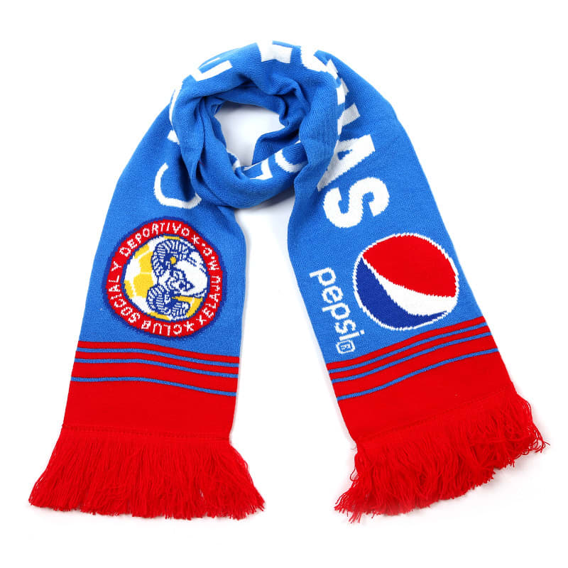 A blue and red knitted scarf with fringe, featuring a logo and branding.
