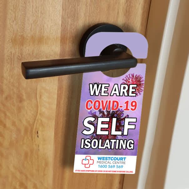 A door hanger in vibrant colours featuring a logo, designed to indicate self-isolation due to COVID-19.