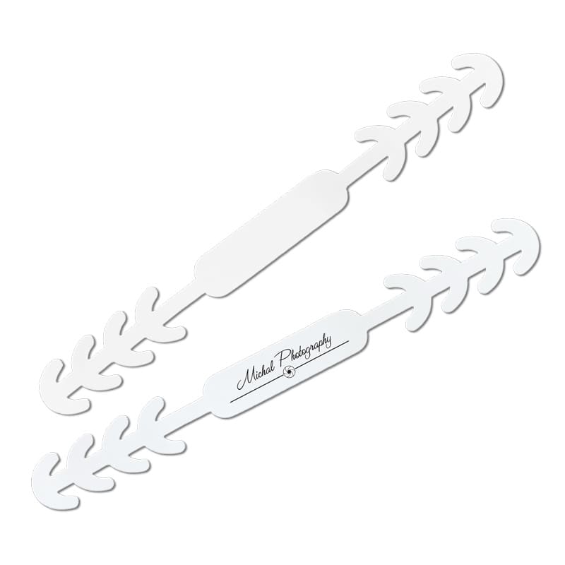 A white PVC face mask fastener with a leaf-like design and an embedded logo.