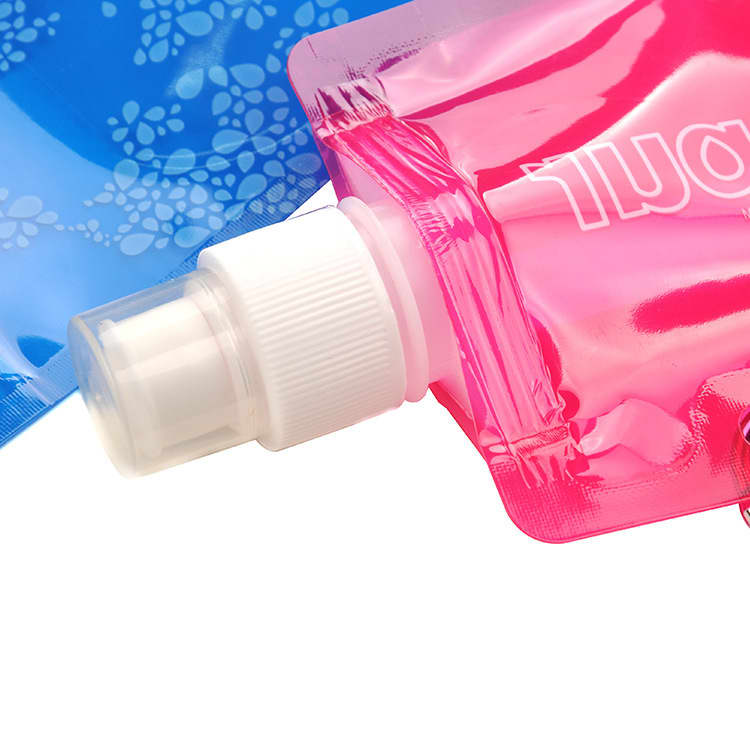 A drink bottle in pink and blue, featuring a twist cap and a flexible, foldable design. Includes a logo.