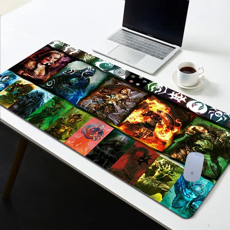 A deluxe fabric gaming mat featuring various vibrant graphics in multiple colours, with a laptop and coffee cup on a table.