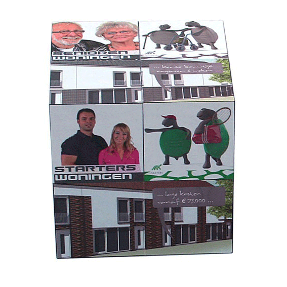 A cube-shaped promotional product with colourful graphics featuring diverse characters and a logo.