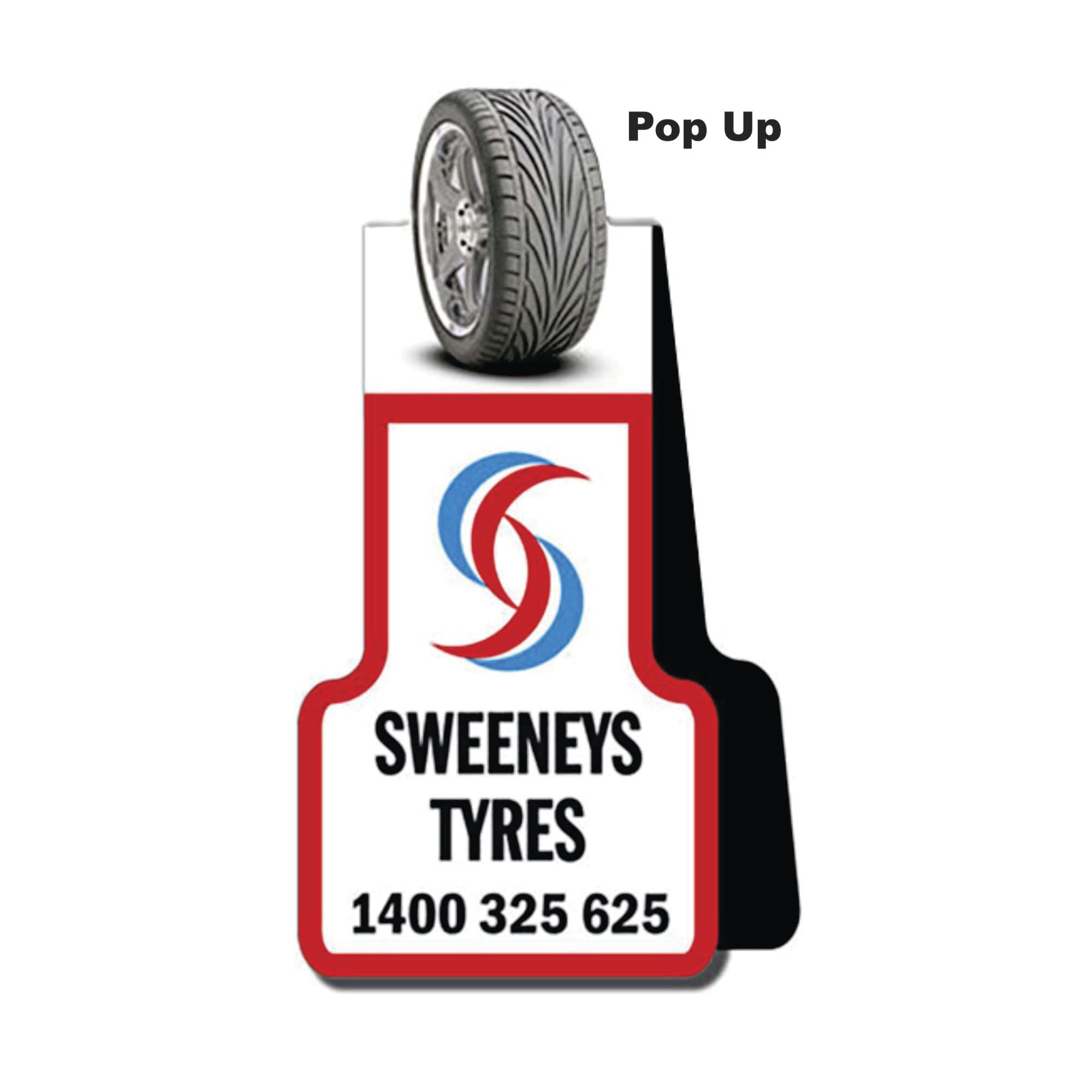A promotional display for Sweeney's Tyres featuring a wheel graphic and logo, predominantly in red, white, and blue.