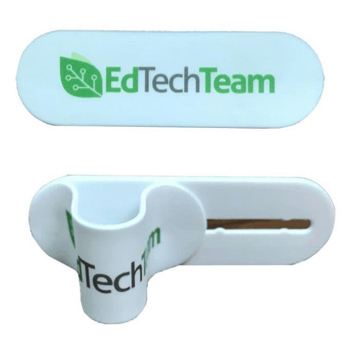 A white phone stand with a slot for a device and a branded logo design on the front.