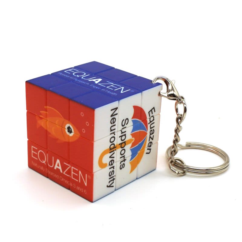 A UV printed twist cube keyring featuring red, blue, and white panels with an attached metal chain.