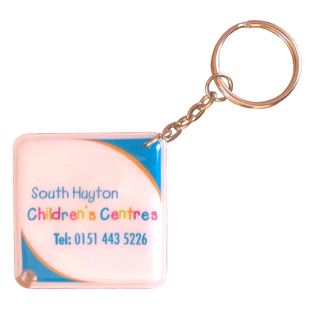 A square PVC keyring with a keychain, featuring a colourful design and a branding logo.