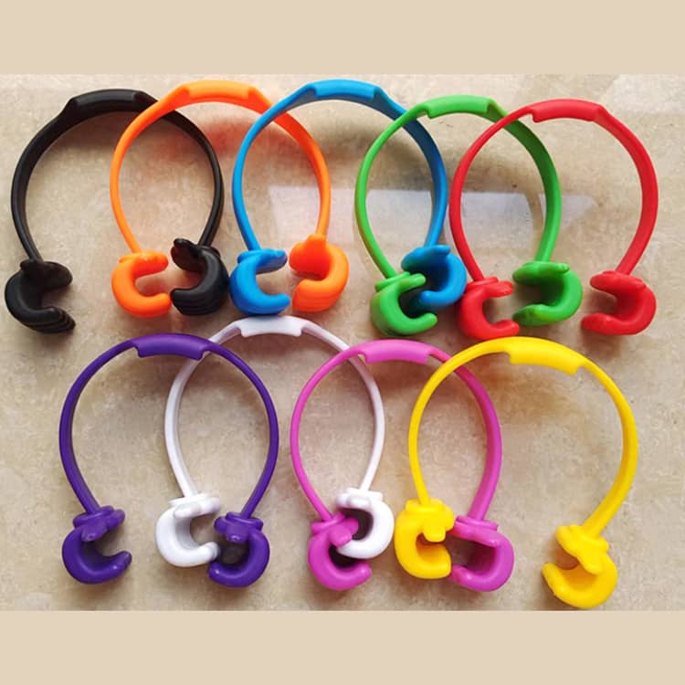 A collection of colourful phone and tablet holders in black, orange, green, purple, blue, and white, featuring a thumbs-up design.