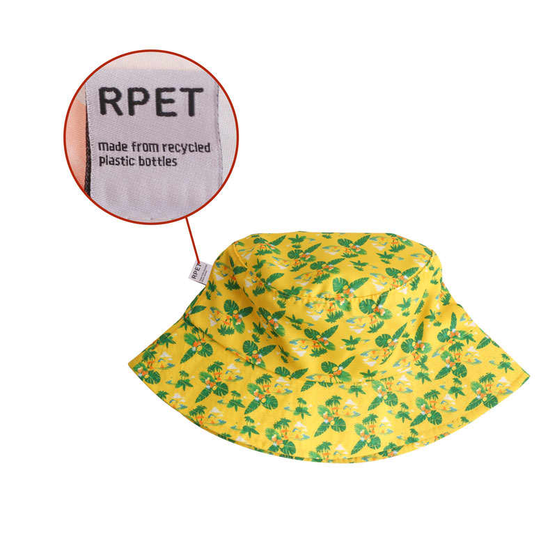 A yellow bucket hat featuring a floral pattern, made from recycled plastic bottles, with a label indicating its material.