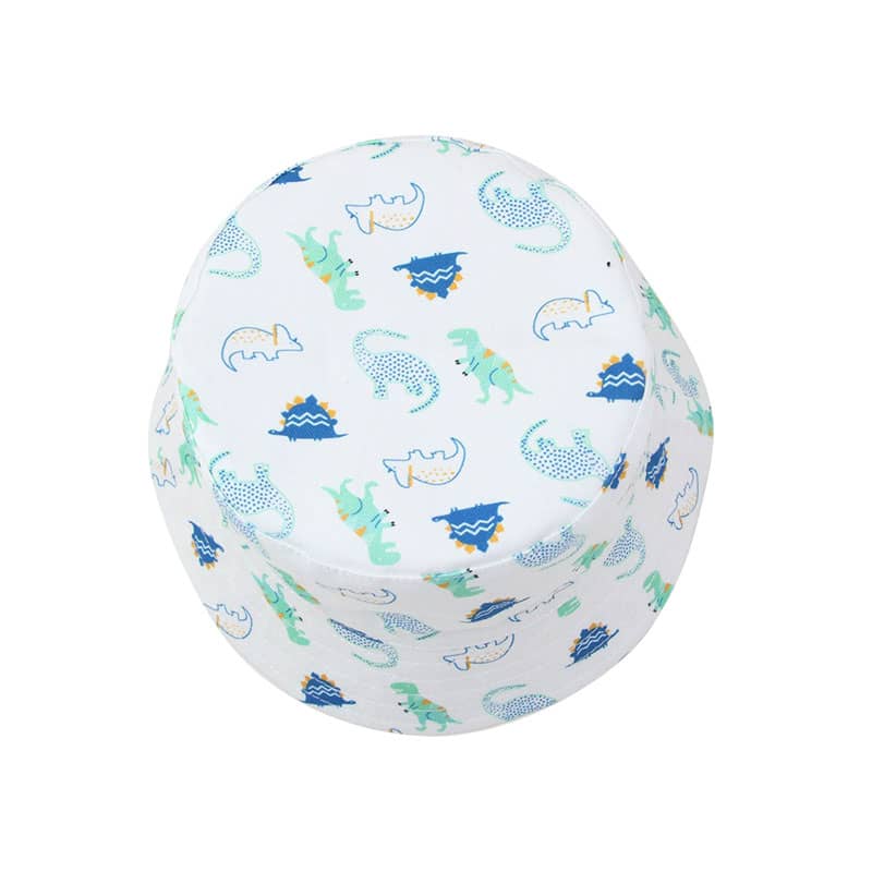 A white bucket hat featuring a playful dinosaur pattern in various shades of blue and green. It has a logo on it.