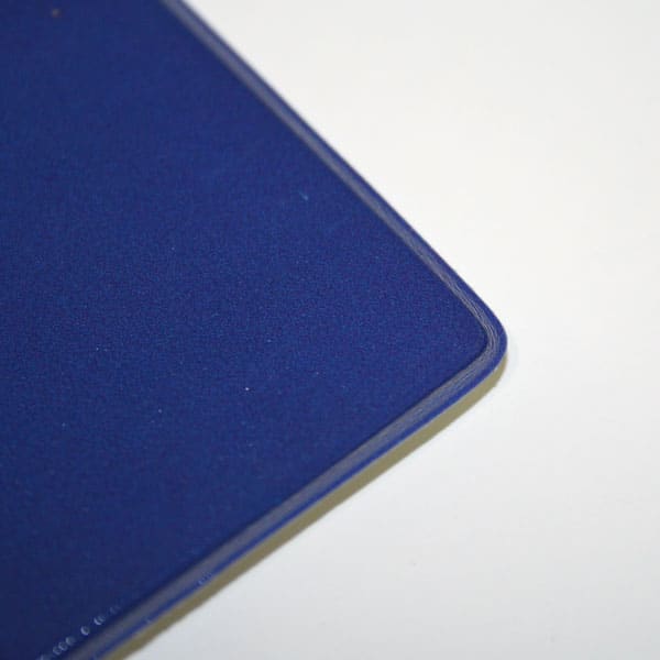 A dark blue welded A3 counter mat with a rounded corner, featuring a smooth surface.